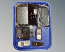 A box containing vintage mobile phones including Nokia and Sony together with three tablets