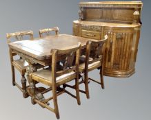A 1930s carved oak eight piece dining room suite comprising of a shaped front buffet back sideboard,