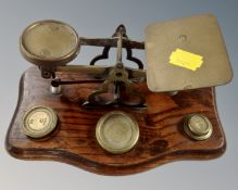 A set of antique brass postal scales with weights