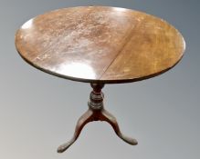 A 19th century circular mahogany tilt topped pedestal occasional table.