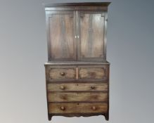 A Victorian mahogany four drawer secretaire chest fitted with a cupboard above.