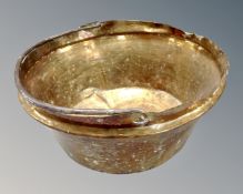 An antique brass cast iron handled cooking pot.