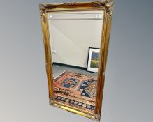 A gilt framed bevelled mirror, 75cm by 137cm.