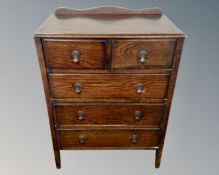 A 1930s oak two over three five drawer chest.