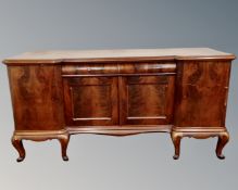 A 19th century mahogany inverted breakfront four door sideboard on raised legs.