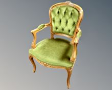 A French beech wood salon armchair upholstered in a green button dralon.
