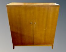 A mid-20th century Danish double door cabinet fitted with internal drawers and shelves.