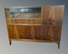 A mid-20th century Scandinavian high board fitted with cupboards drawers and sliding glass doors.