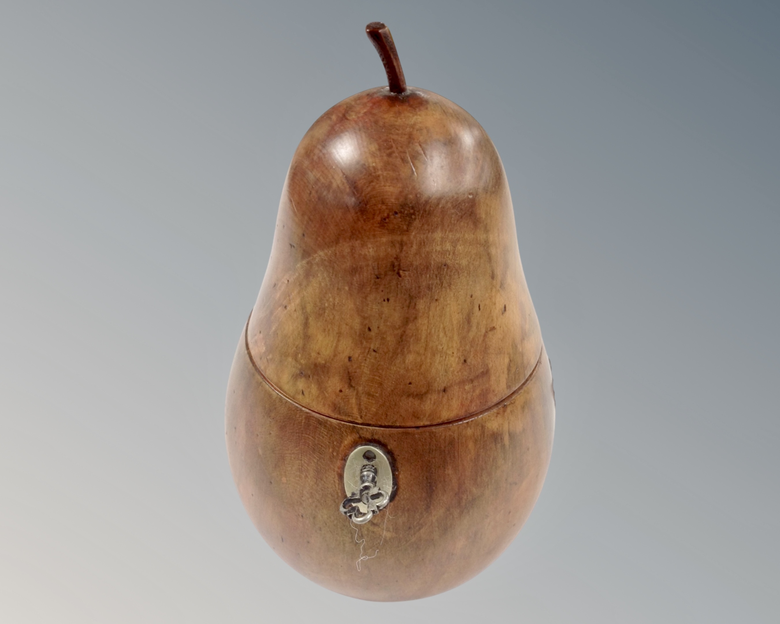 A George III style turned fruitwood tea caddy in the form of a pear.