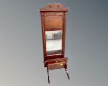 An antique mahogany wall mirror together with wall shelf fitted with a drawer.