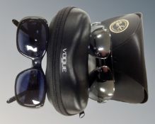 A pair of Ray-Ban sunglasses and a pair of Vogue sunglasses with prescription lenses,