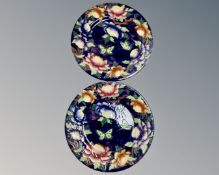 A pair of Maling plates depicting flowers and butterflies.