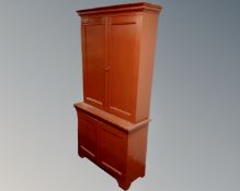 An antique painted pine and oak double door cabinet fitted with cupboards beneath.