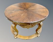 A 20th century stained beech circular coffee table on carved legs.