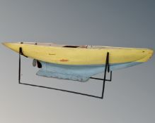 A 20th century painted wooden pond yacht on metal stand,