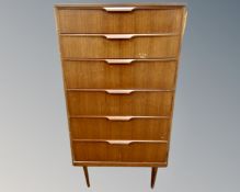 An Austinsuite teak six drawer chest on raised legs.