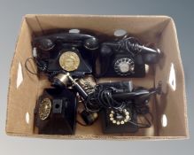 A box containing four retro style telephones.