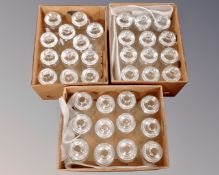 Three boxes containing a large quantity of lidded glass storage jars.