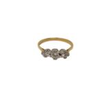 An 18ct gold three stone diamond ring, size N CONDITION REPORT: 2.