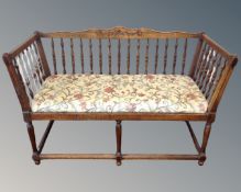 A carved beechwood twin window seat with tapestry cushion.