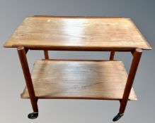 A mid-20th century Paul Hundevad Vamdrup Danish two tier serving trolley retailed by Chapmans.