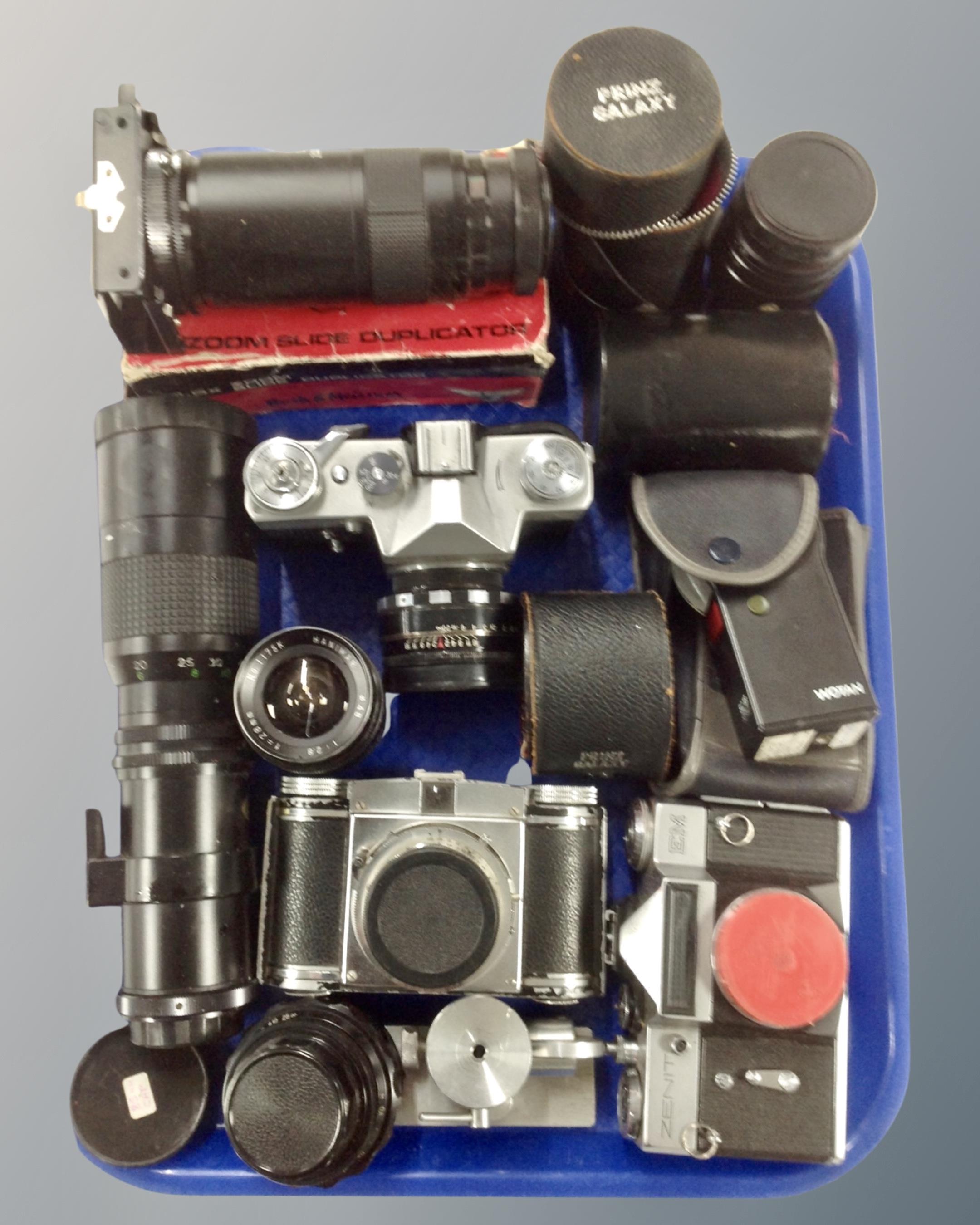 A tray containing a collection of vintage cameras including Zenit EM, Zenit-B, Paxina 29,