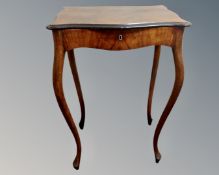 A 19th century walnut shaped work table on cabriole legs.