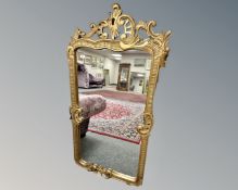 A continental mirror in gilded wood frame, 73cm by 144cm.