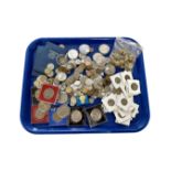 A tray of crowns, military buttons, assorted British and American coins,