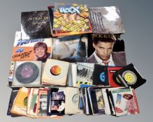 A box containing a quantity of vinyl LP's and 7" singles to include compilations, Prince,