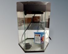 A hexagonal fish tank with filter.