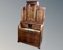 A 19th century Biedermeier cylinder bureau secretaire fitted with four drawers below and cupboards