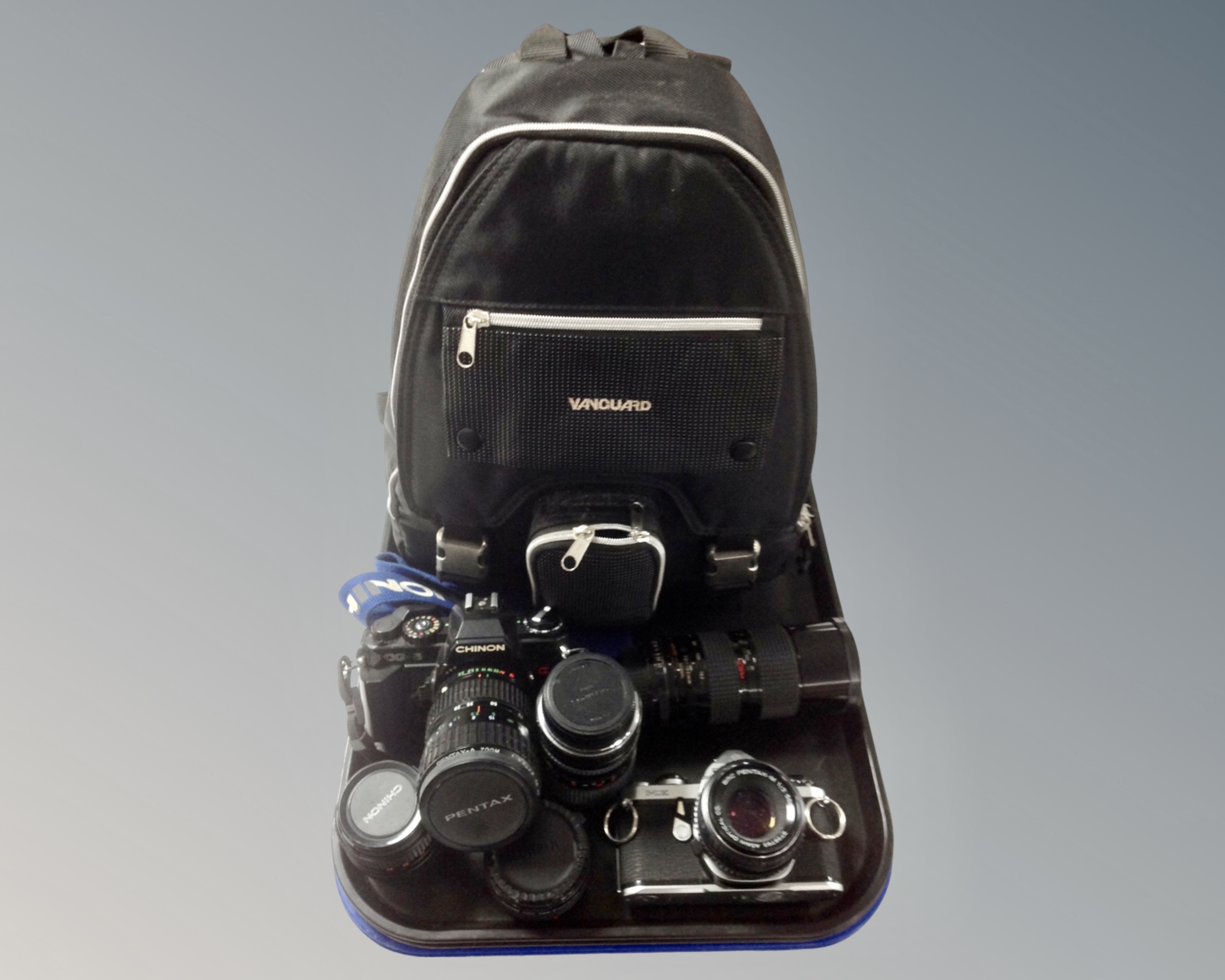 A tray containing a Chinon CG-5 SLR Camera, a Pentax ME SLR Camera,