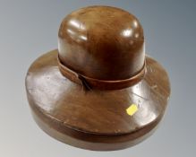 A wooden Milner's hat stand in the form of a lady's hat