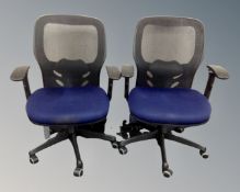 Two contemporary office adjustable swivel armchairs with fabric seats and mesh backs.