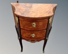A Louis XV style shaped two drawer chest on raised legs.