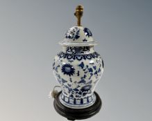 A Chinese blue and white lidded vase on wooden stand, height 42cm,