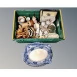 A crate containing Eastern wooden carvings, a pottery jelly mould,