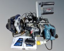 A box containing power tools including a compound mitre saw, Makita jig saw (110v), Pro handsaw,