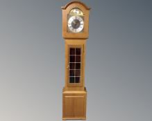 A Tempus Fugit longcase clock with pendulum and weights.