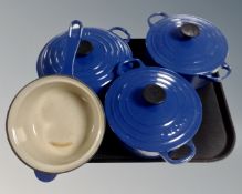 A Le Creuset twin handled enamelled dish together with two further dishes, saucepans etc.