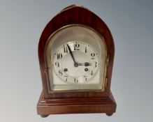 A teak Junghans bracket clock with silvered dial on ball feet