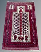 An Afghan prayer rug, 155cm by 101cm.