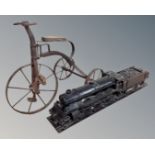 A miniature penny farthing together with a wooden folk art model of a train.