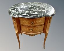 A French Louis XV style marquetry inlaid two drawer bedside table with marble top and raised legs.