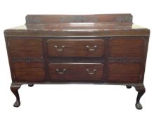 An Edwardian mahogany sideboard on claw and ball feet.