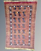 An Afghan rug, 142cm by 85cm.