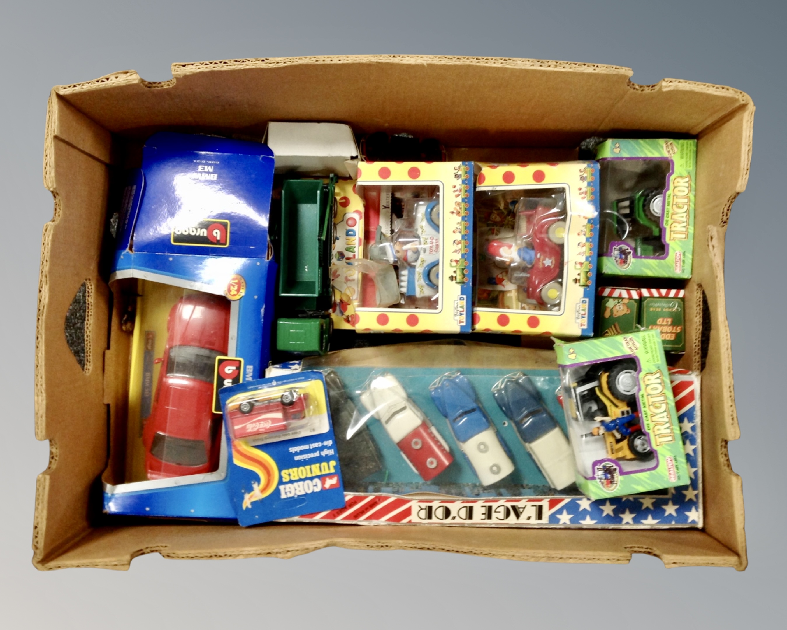 A box containing mostly boxed models including Burago BMW M3, Corgi Juniors model, Noddy model etc.