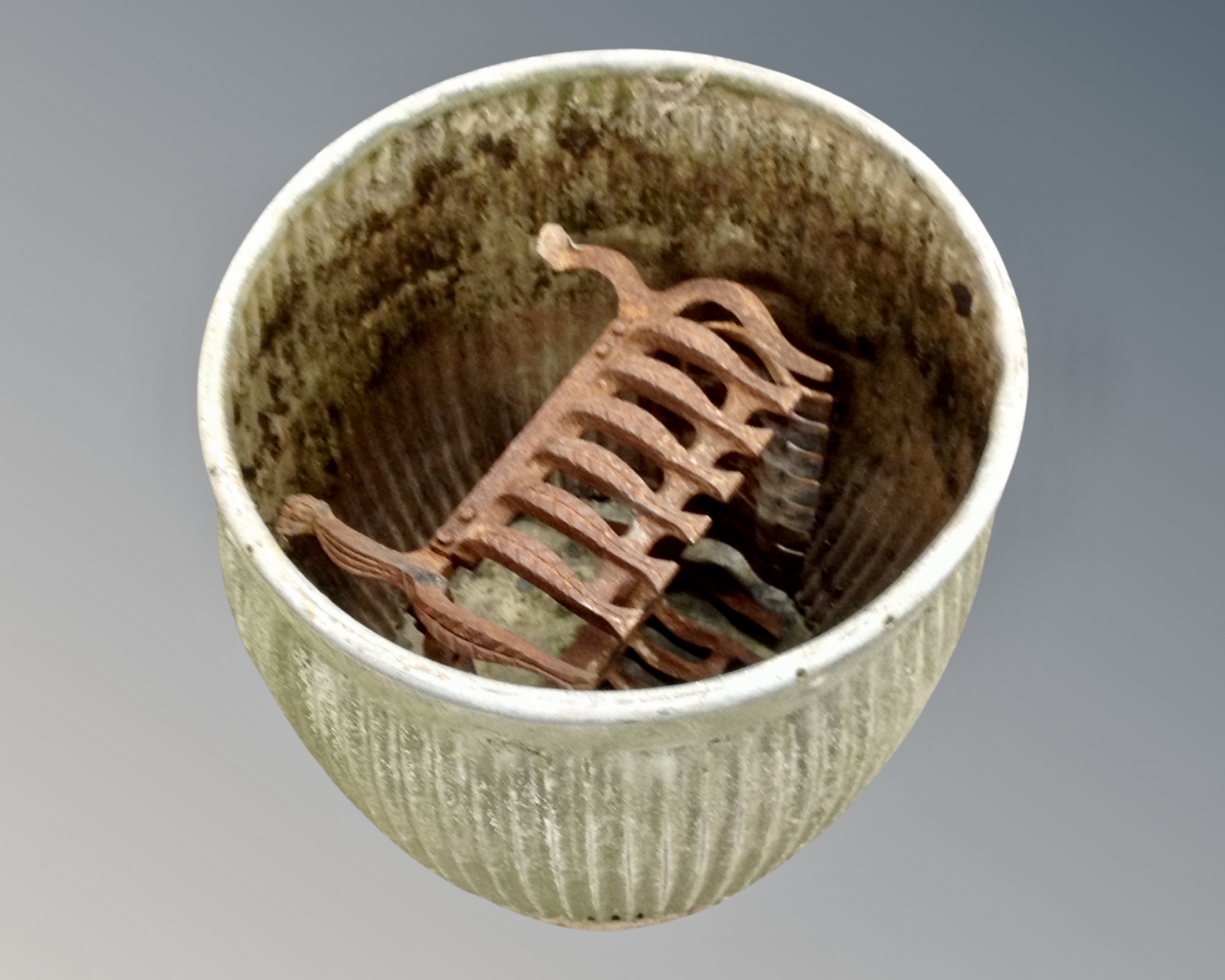 A galvanized metal wash tub together with a cast iron fire grate.