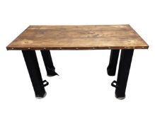 An Industrial style pine plank topped table with metal base.